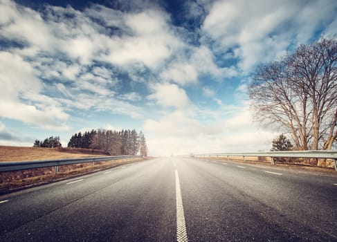black asphalt road on sunny spring day