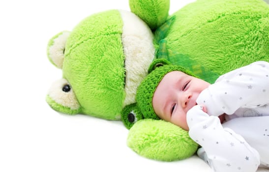 baby in frog hat and soft toy