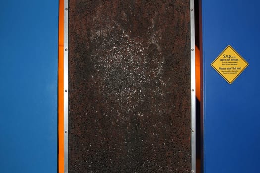View of sketches of faces on a soft nail board with blue panels on each side