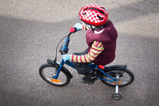 Boy on bike at asphalt road in spring
