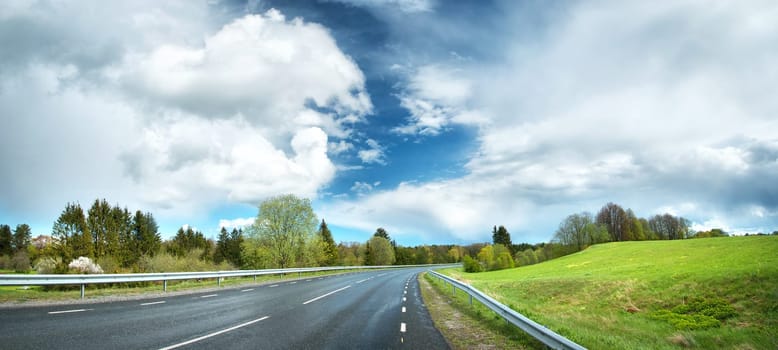 wet road panorama with beautiful clouds in the sky