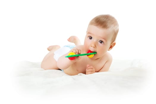 Baby holding a toy isolated on white background
