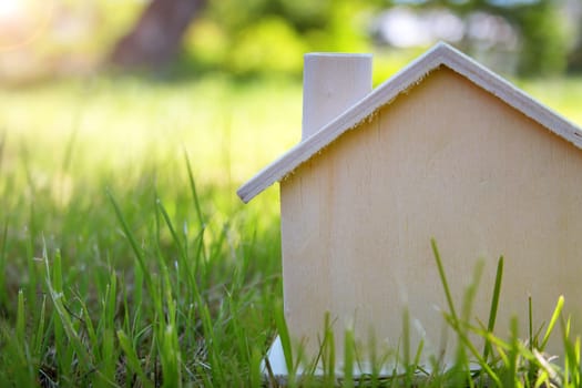wooden house toy on the grass in garden
