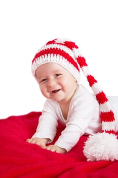 little baby in knitted red whitey hat on red blanket