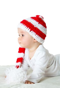 little baby in knitted red whitey hat on red blanket