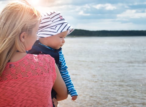 young woman and baby at the beach near sea