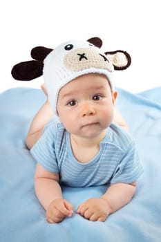 cute baby in a cow hat on blue blanket