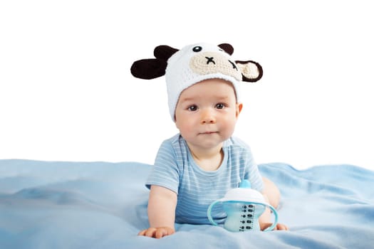 cute baby in a cow hat drinking milk