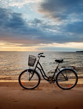 Lonely bike standing at sunset at seaside