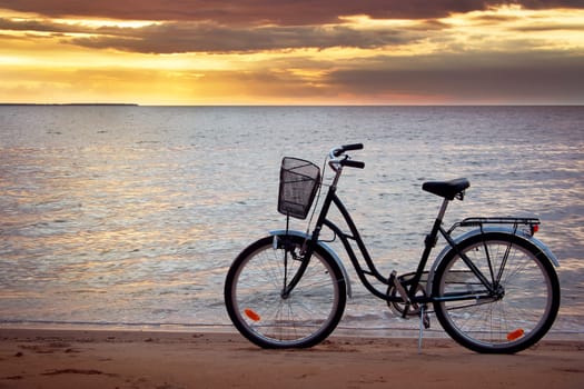 Lonely bike standing at sunset at seaside
