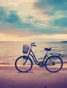 Lonely bike standing at sunset at seaside