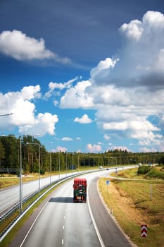 a container truck moving on highway on sunny dat