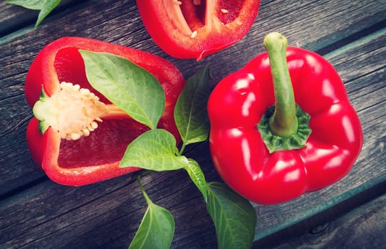 Fresh sweet red pepper on old wooden background