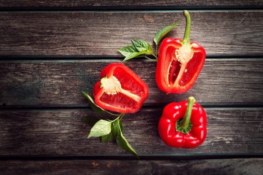 Fresh sweet red pepper on old wooden background