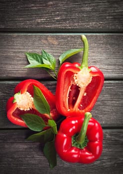 Fresh sweet red pepper on old wooden background