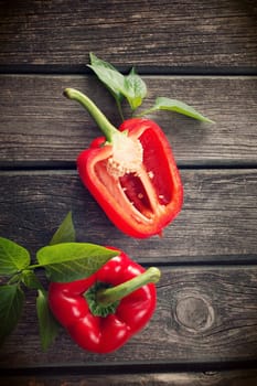 Fresh sweet red pepper on old wooden background