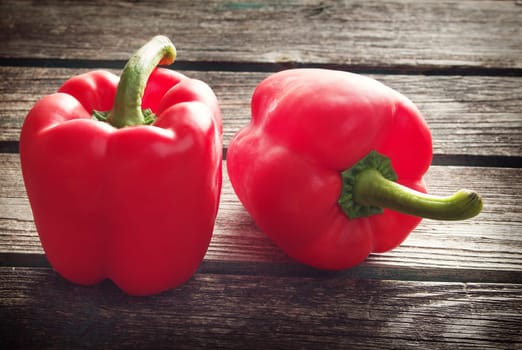Fresh sweet red pepper on old wooden background