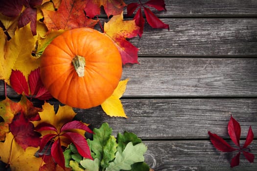 yellow pumpkin on old weathered wooden background