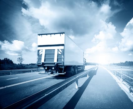 tilt truck moving on the asphalt road