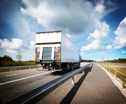 tilt truck moving on the asphalt road