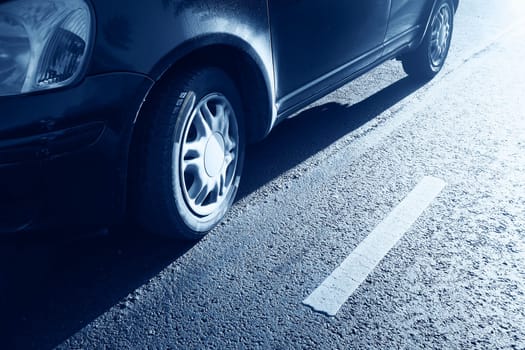 car tires on asphalt road with a dividing line