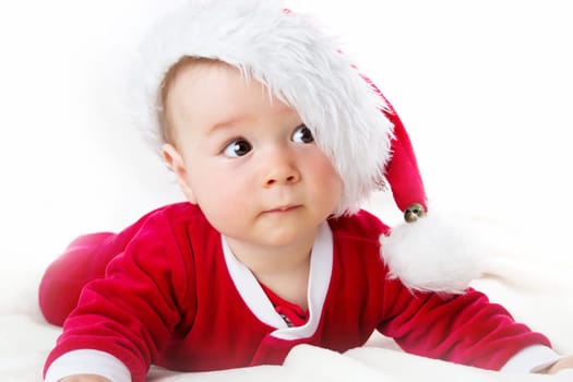 eight month old baby on white background in santa costume