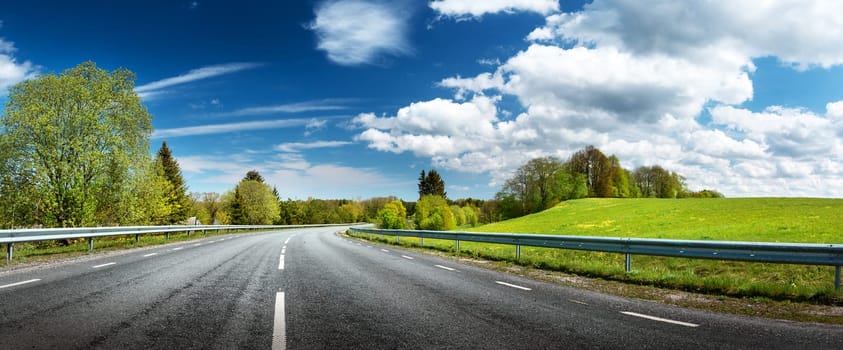 asphalt road panorama in countryside on sunny spring day