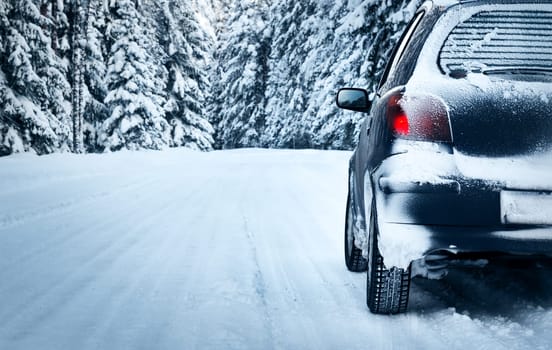 car on winter road in the forest
