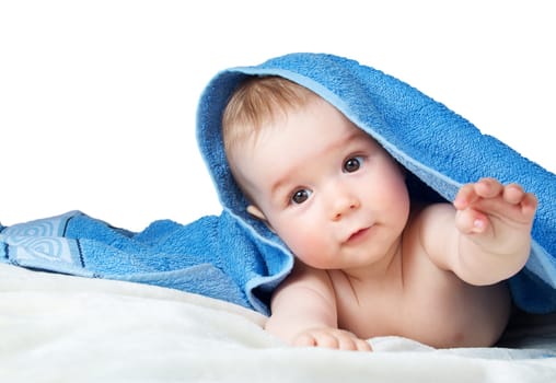 Cute eight month old baby wrapped in a towel isolated on white background
