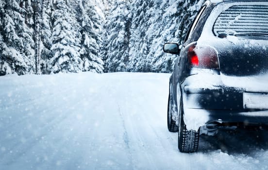 car on winter road in the forest