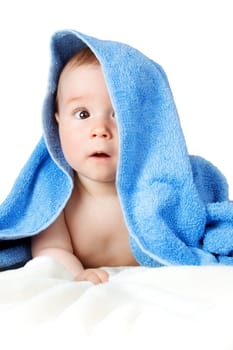 Cute eight month old baby wrapped in a towel isolated on white background