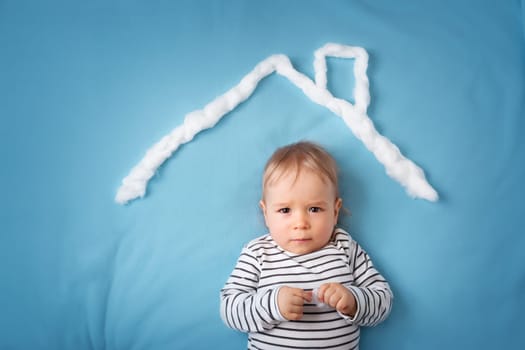little boy with shape of house roof on the blue background