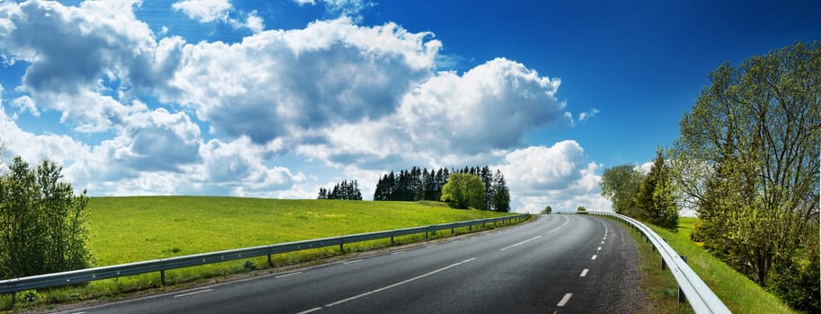 asphalt road panorama in countryside on sunny spring day