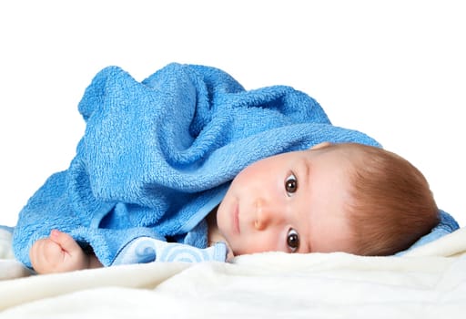 Cute eight month old baby wrapped in a towel isolated on white background