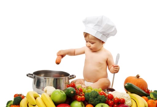 Baby boy in chef hat with cooking pan and raw vegetables