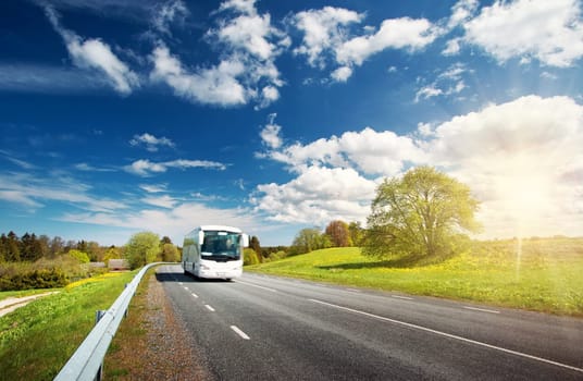 Bus on asphalt road in beautiful spring day at countryside