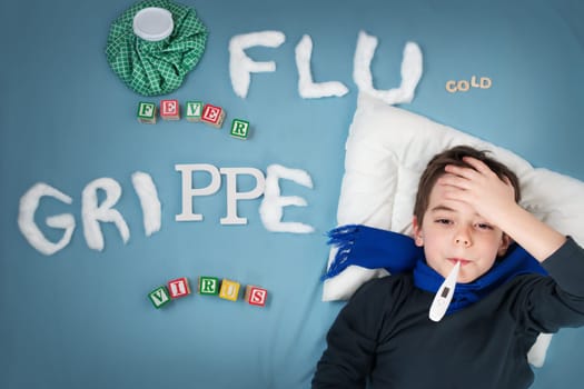 Ill boy lying in bed. sad child with fever and