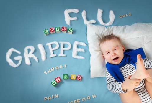 Ill boy lying in bed. baby with grippe text