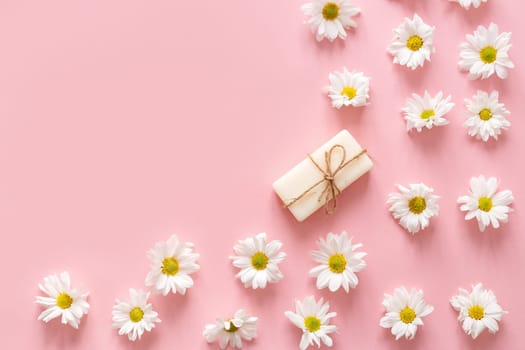 Flat lay composition with hand made soap bars and lavender flowers on violet background