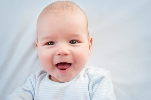 3 month old baby lying in bed