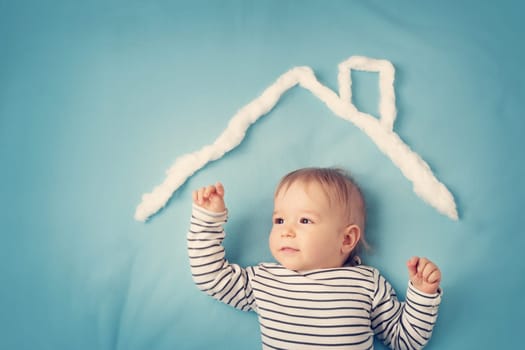 little boy with shape of house roof on the blue background