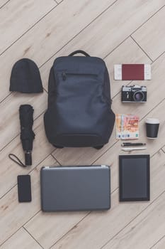Knolling of backpack and a set of all the necessary attributes for a short trip to Europe or a business trip for a man, top view