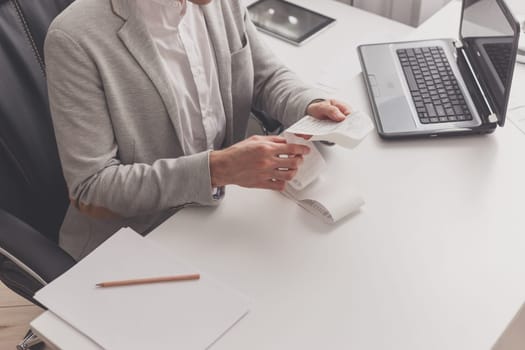 Man watches a check while sitting at a table