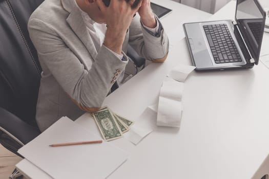 Young man frustrated at his house by debt.