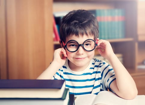 seven years old child reading a book at home
