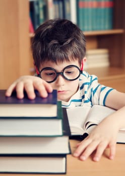 seven years old child reading a book at home