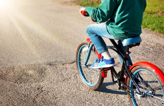 child on a bicycle at asphalt road
