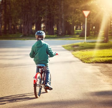 child on a bicycle at asphalt road
