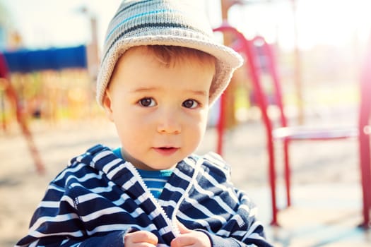 Little boy playing on playground in the spring