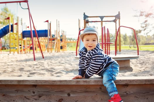 Little boy playing on playground in the spring